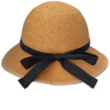 Rear view of a straw-hat-style bicycle helmet, featuring a woven texture and a black ribbon band tied in a bow. The brim’s edge is trimmed in beige. The helmet is shown against a white background.