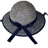 Back view of the Shibori Blue Straw Hat Bike Helmet showing the woven brim and navy ribbon bow.