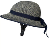 Side view of the Shibori Blue Straw Hat Bike Helmet with navy ribbon detailing.