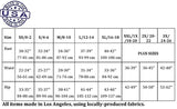 Women's clothing size chart with measurements in inches and centimeters. Sizes XS (0-2) to 3X (24-26). Bust 30–32 in (77–81 cm) up to 52–62 in (132–157 cm). Waist 22–24 in (56–61 cm) up to 42–48 in (107–122 cm). Hip 33–35 in (84–88 cm) up to 52–62 in (132–157 cm). Made in Los Angeles using locally-produced fabrics.