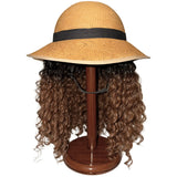 Bike Pretty Helmet Hair straw hat bike helmet with curly hair extensions on hat stand, front view showing full curls