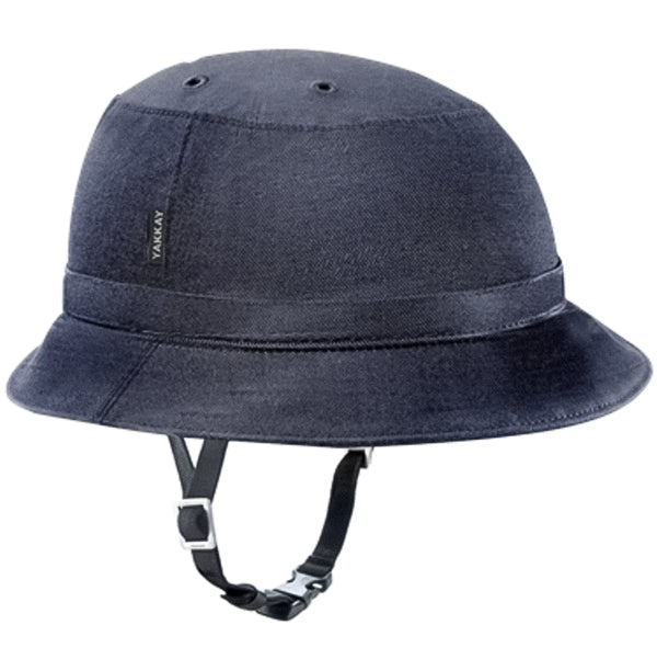 On a plain white background, a dark denim, bucket hat-style helmet cover is installed onto a bike helmet. Viewed from a three-quarter perspective, the black chin strap of the helmet is visible below the brim of the cover.